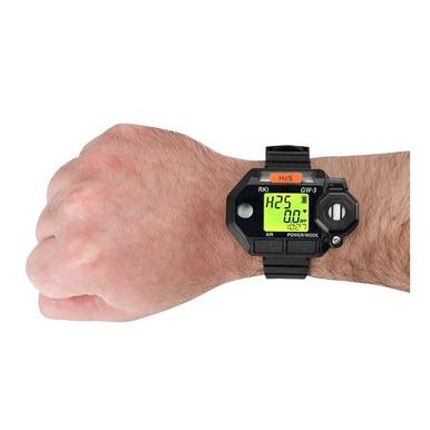 A person's wrist wearing an RKI Instruments GasWatch 3 H2S Single Gas Monitor 73-0022 in black, with a green-lit screen displaying numbers and symbols. Designed specifically for refineries, this monitor features a robust design and multiple buttons on the sides.