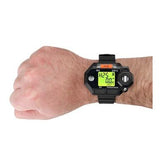 A person's wrist wearing an RKI Instruments GasWatch 3 H2S Single Gas Monitor 73-0022 in black, with a green-lit screen displaying numbers and symbols. Designed specifically for refineries, this monitor features a robust design and multiple buttons on the sides.