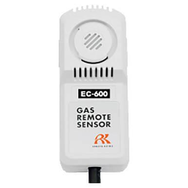 The RKI Indoor CO Diffusion Gas Monitor, model EC-600 by RKI Instruments, serves as a Carbon Monoxide Detector. It showcases a logo and the brand name "Riken Keiki" and features a circular vent pattern at its top with an Electrochemical Sensor. A black cable extends from its bottom.