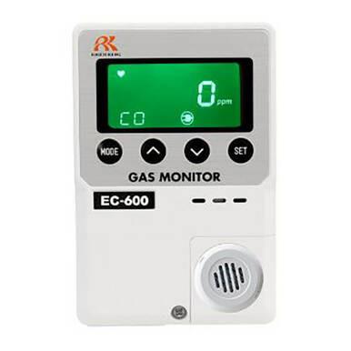 The RKI Instruments indoor CO diffusion gas monitor, model EC-600, features a green digital display showing "0 ppm" for carbon monoxide levels. This white device is equipped with mode and set buttons, as well as a round speaker grill in the bottom right corner, ensuring safety with its reliable electrochemical sensor.