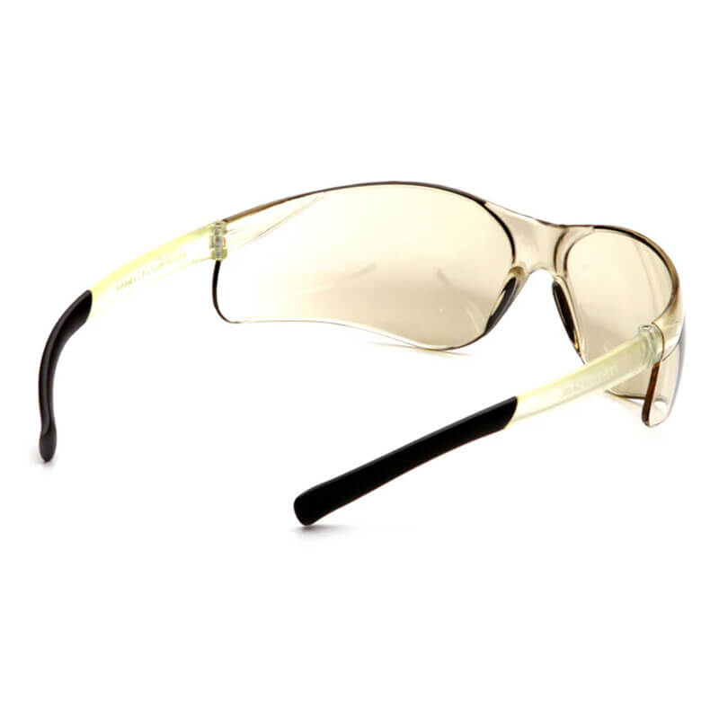 Pyramex Safety Ztek S2510S Safety Glasses (12/box) feature clear, slightly tinted wraparound lenses with black nose bridge and black-tipped arms, shown from an angled side view. ANSI Z87.1 rated for eye protection.