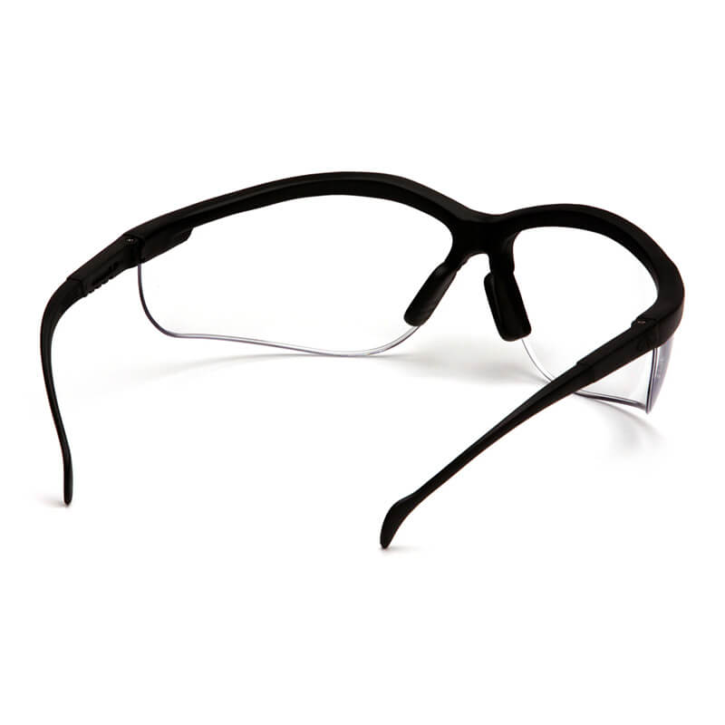 A box of Pyramex Venture II Safety Glasses by Pyramex Safety features black frames, clear lenses, and a rear view showing curved side arms, nose pads for comfort, and built-in UV protection for reliable eye safety.