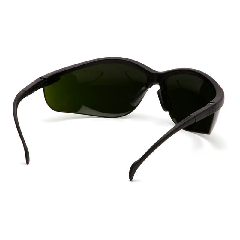 A pair of Pyramex Venture II Welding Safety Glasses SB18_0SF by Pyramex Safety, featuring black wraparound frames and dark green lenses, shown from the back at an angle with arms extended.