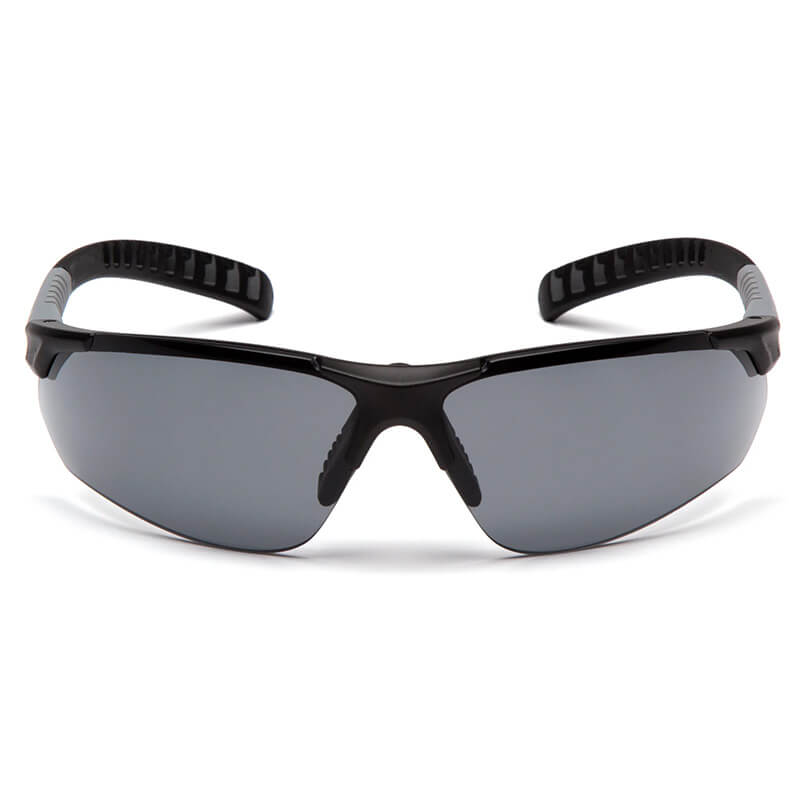 The Pyramex Safety Sitecore Safety Glasses SBG101_0DTM feature black wraparound frames, dark tinted lenses, and adjustable temples, shown from the front on a white background. Sold in boxes of 12.