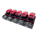 Six red and black RKI Instruments SDM-04 Calibration Stations (Toxics) 81-SDM04SC-10_ are lined up in two rows, each with digital displays and labeled buttons for portable gas monitor calibration and bump testing.