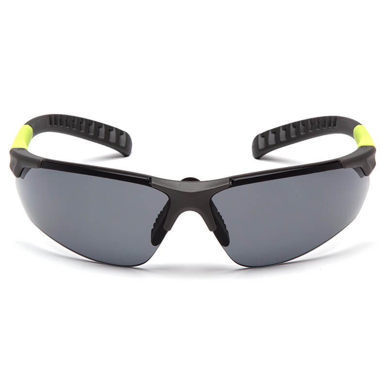 The Pyramex Sitecore Safety Glasses SGL101_0DTM by Pyramex Safety feature a black aerodynamic wraparound frame, dark lenses, green accents, ribbed inner grips for comfort, and an anti-fog coating for clear vision. Sold as 12 per box.