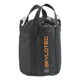 The Skylotec Rope Bag ACS-0009- is black and cylindrical, featuring two handles and the brand name "Skylotec" in orange lettering along the side. It appears durable and sturdy, with metal rings near the handles, making it ideal for organizing climbing gear like ropes.