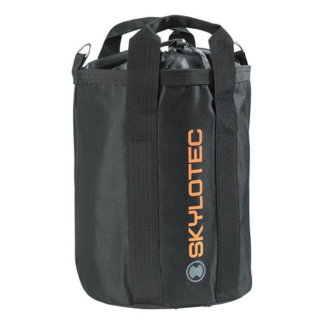 A black cylindrical Skylotec Rope Bag ACS-0009 prominently showcases the "Skylotec" brand in vibrant orange letters on its side. Ideal for climbing rope, it includes sturdy handles and a drawstring closure at the top, keeping your gear secure and easily accessible.