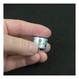 A hand holds a Replacement O2 Sensor for GasAlert Monitors SR-X2V by BW Technologies (Honeywell), showing three gold pins, a QR code, and printed text on its surface, set against a black background.