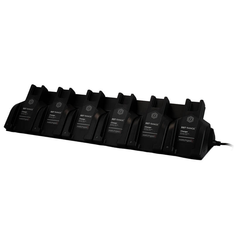 A WatchGas SST 6 Way Bench Top Charger (SST-6WSCC-KIT) by WatchGas, holding six labeled battery packs, is displayed on a white background. This centralized charging solution is plugged in on the right side, enabling efficient charging for up to six devices simultaneously.