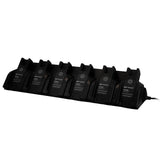 A WatchGas SST 6 Way Bench Top Charger (SST-6WSCC-KIT) by WatchGas, holding six labeled battery packs, is displayed on a white background. This centralized charging solution is plugged in on the right side, enabling efficient charging for up to six devices simultaneously.
