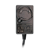 The WatchGas SST 6 Way Bench Top Charger (SST-6WSCC-KIT) by WatchGas is a black AC/DC power adapter with technical specifications and certification logos displayed on the front. Designed as part of a centralized charging solution, it features a circular connector holder and a cable extending from the bottom, making it ideal for efficient six-device charging with the SST Range 6-Way Charger systems.