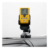 A yellow WatchGas SST Range device with a digital display is held by the WatchGas SST Range Wireless Car Charger SST-CAR-CHG, mounted on a car dashboard via suction cup and powered by a USB cable. The device screen shows numbers and abbreviations.