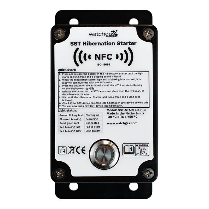 A close-up of the WatchGas SST1 Hybernation Starter SST1-HS device featuring an NFC symbol, quick start instructions, a light signal guide, and a metal button on the front panel—ideal for ensuring safety detector compliance tracking in industrial environments.