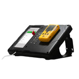 The WatchGas SST Kiosk SST-KIOSK, a rugged black touchscreen device with a charging cable and yellow handheld gadget on top, is shown on a white background—ideal for managing gas detectors.