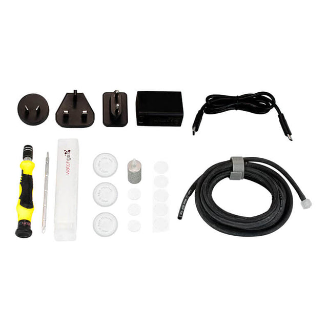 WatchGas SST4-PUMP Sampling & Charging Kit SST4-PUMP-ACC by WatchGas, featuring a comprehensive electronics repair kit with screwdriver, global power adapters, power supply, USB cable, cleaning tools, hose, pump filter options, and various small components—including the SST4-Pump accessories kit—all neatly arranged on a white background.