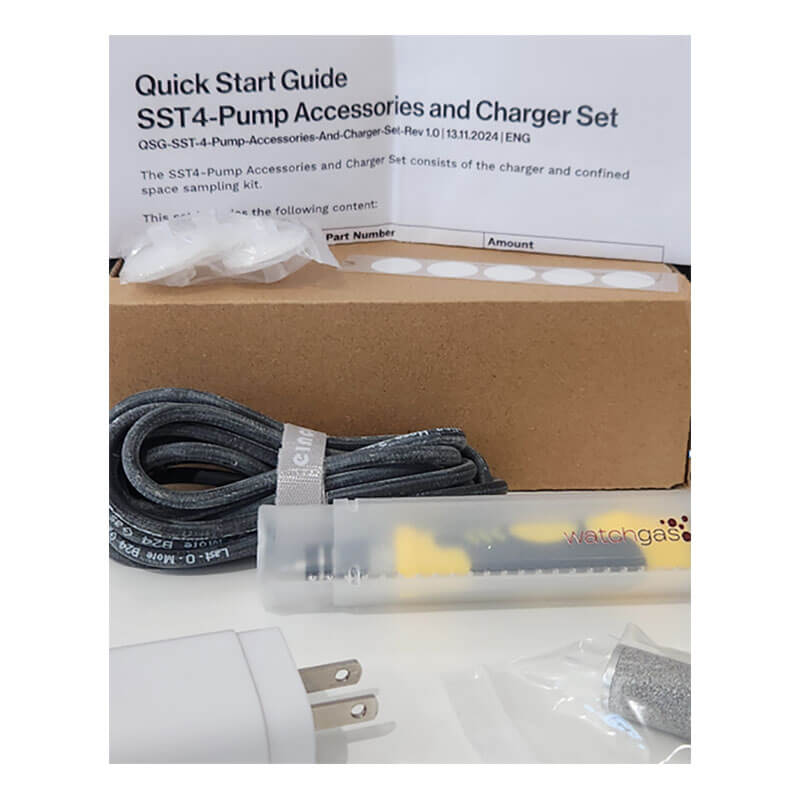 A quick start guide, charger plug, USB cable, syringe-like device labeled "WatchGas," small filter, and brown box are arranged together as accessories and charger set for the WatchGas SST4-PUMP 4-Gas Detector by WatchGas.