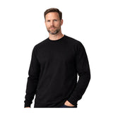 A man with short brown hair and a beard stands against a white background, wearing the ForgeFR Forge FR Crew Neck Tee MFRCNT-009. With his left hand in his pocket, he displays protective workwear in a simple, timeless style.