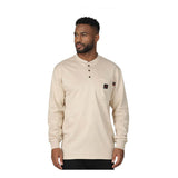 A man wears the ForgeFR Forge FR Henley MFRHNLY-004, a beige, long-sleeve arc rated shirt with three collar buttons and a logo patch, standing against a white background to showcase durable flame resistant apparel.