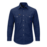 The ForgeFR Solid Shirt Denim MFRSLD-002 from ForgeFR embodies a classic workwear style with its blue denim design, two chest pockets, and white buttons. The shirt features visible stitching and is set against a plain white background, delivering a timeless look that seamlessly complements any flame-resistant clothing collection.