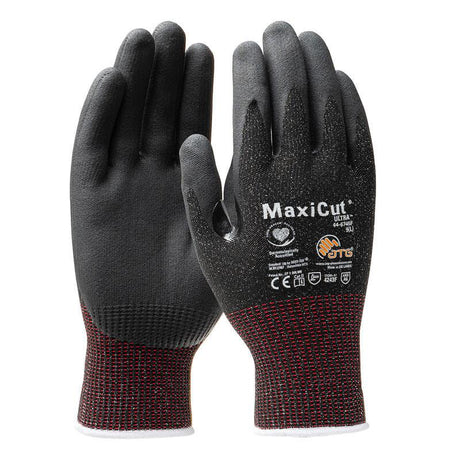 A pair of PIP MaxiCut Ultra Nitrile MicroFoam A6 Gloves 44-6745F, available in black and red, featuring a Nitrile MicroFoam Grip on the palms and fingers for improved hold. These gloves are touchscreen compatible and have various safety icons along with branding printed on the back of the hands.