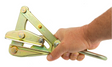 A hand grips the PK Safety Supply Test Product 2, a metallic wire strainer or tensioner tool with multiple pivot points and bolts, designed for tightening and securing wire fencing.