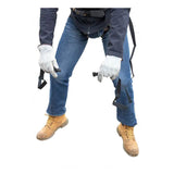 A person holds the French Creek U-STEP Suspension Trauma Straps (Pair) by French Creek Production, shown from shoulders down with blue jeans, dark jacket, and tan work boots, against a white background for optimal fall protection.