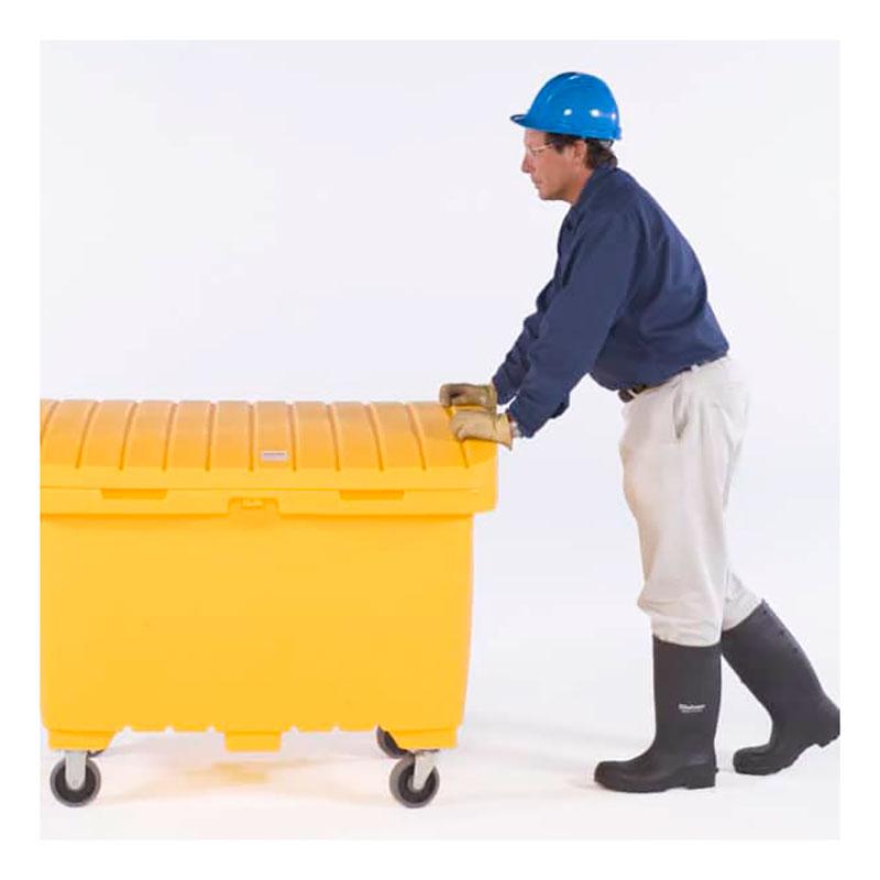 A person wearing a blue hard hat, gloves, and black rubber boots is pushing a large UltraTech Utility Box 086_ from UltraTech International on wheels. The backdrop is plain white.