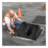 A person wearing an orange safety vest and gloves installs an UltraTech Economy Frame Model Drain Guard 8935- from UltraTech International over a storm drain on a paved surface. An orange traffic cone is placed nearby.