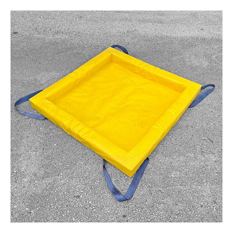 The UltraTech Containment Berm - Foam Wall XC Model 898 from UltraTech International, featuring a vibrant yellow color and constructed with durable EVA material, includes blue straps and is set on a gray asphalt surface. This square-shaped berm is designed to function efficiently even in extremely cold conditions, making it appear ready for deployment.