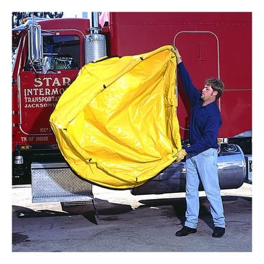 Next to a red truck with gleaming chrome details, an individual unfolds the UltraTech Economy Model Pop Up Pool 8_ _ _-YEL from UltraTech International. The sizable yellow pool is spread open, highlighting its potential application for spill containment. In the background, the truck's door hints at preparedness for emergency response operations.