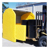 A forklift is transporting an UltraTech Hard Top P4 Plus Spill Pallet from UltraTech International, which functions as a yellow, plastic shelter to shield and secure multiple black barrels for outdoor storage. This shelter is designed with an open side and is situated near an industrial building.