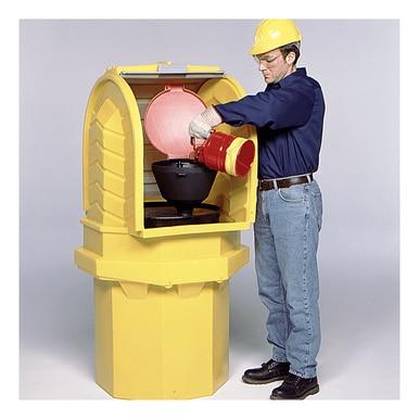 Inside a spacious yellow outdoor containment unit, an individual equipped with a hard hat and protective gloves meticulously pours a red liquid from a red container into a black funnel, showcasing the efficiency of the UltraTech International Hard Top P1 Plus Spill Pallet 964_ in safely managing 55-gallon drum storage.