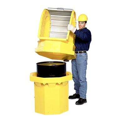 A person in a hard hat and gloves secures the yellow drum lid onto an UltraTech Hard Top P1 Plus Spill Pallet 964_ from UltraTech International, which is designed for storing a black 55-gallon drum. The container features a ribbed exterior suitable for industrial use.