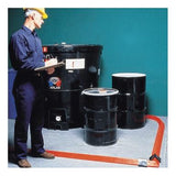 A man in a yellow hard hat and blue uniform is holding a clipboard, standing beside three black industrial barrels. The floor is lined with UltraTech Spill Berms by UltraTech International, which offer temporary secondary containment in an orange hue against a teal-colored wall as the backdrop.