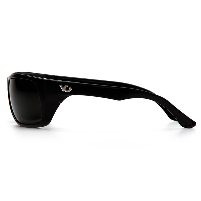 A pair of Pyramex Venture Gear Vallejo black wraparound polarized sunglasses with dark lenses and a small silver logo on the arm is shown from the side on a plain white background.