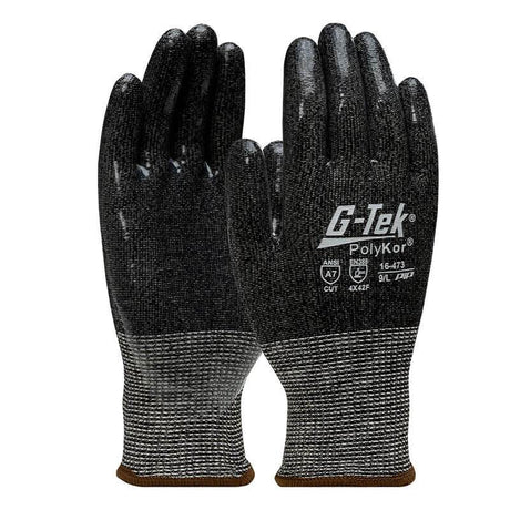 A pair of black and grey PIP G-Tek PolyKor Gloves, designed with a rubberized, silicone-coated grip on the palms and fingers. Branded as "PIP - Protective Industrial Products," these gloves bear the specifications "16-473" and are rated "4X42F" for cut resistance, featuring brown trim at the wrist for added style.