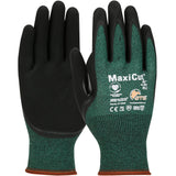 The "PIP MaxiCut Oil Seamless Knit Glove 44-304" by PIP - Protective Industrial Products, features a green and black design with cut resistance and nitrile-coated, textured palms and fingers. Enhanced with various certification symbols and an orange elastic cuff, these breathable gloves offer both comfort and protection.