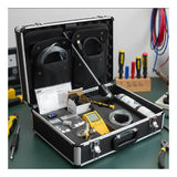 An open black tool case on a workbench contains a BW Technologies by Honeywell GasAlert Max XT II Complete Confined Space Kit, XT-XWHM-Y-NA-CS, along with cables, manuals, tools, and components. Screwdrivers and pliers are also seen in the background.