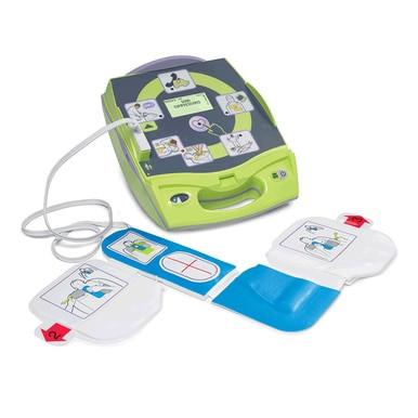 A ZOLL AED Plus Defibrillator Package 8000-0040_ _-01 by ZOLL is shown open on a white background, featuring illustrated instructions and attached electrode pads in a green and gray design.
