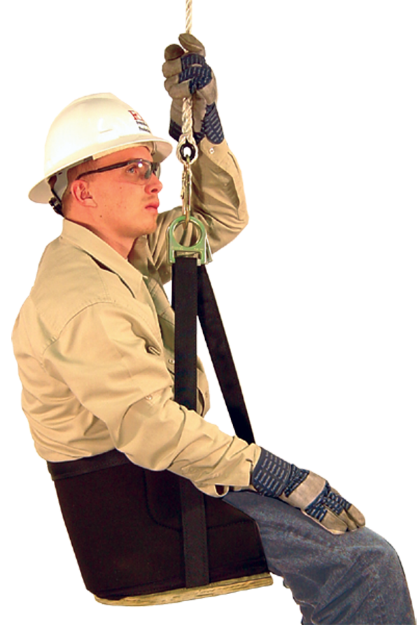 A person, equipped with a hard hat, safety glasses, and gloves, sits confidently in a French Creek Deluxe Work Seat 4153 by French Creek Production. Wearing a beige shirt and jeans, they seem prepared for work at height or in a safety training environment, highlighting strong fall protection measures.