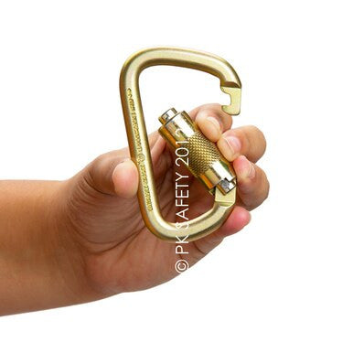 A hand holds a gold-colored, Steel D-shaped carabiner with a screw-lock mechanism against a white background. The carabiner, identified as the Skylotec Steel D-Shaped TW Carabiner H-129, exemplifies Skylotec's renowned safety standards for reliable fall protection.