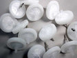 A selection of RAE Systems 45 mm External Filters, model number 002-3022-100, positioned haphazardly on a gray surface. These white plastic products include PTFE Teflon membranes, disc-shaped bodies, and small nozzles.