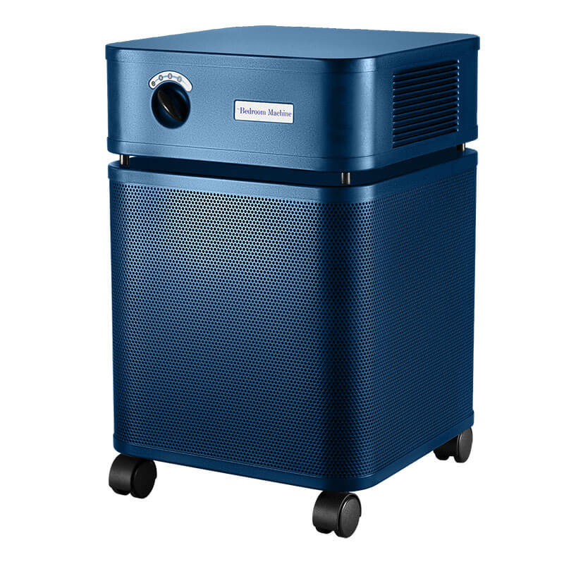 The Austin Air Systems Bedroom Machine B402 is a blue air purifier with a perforated metal body, top vents, control knob, and four wheels. It features a medical-grade HEPA filter for effective air purification.