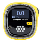 The Honeywell BW Solo Gas Detector H2S by BW Technologies features a black display screen showing "0.0" PPM for H2S. Part of the Honeywell Safety Suite, it has a yellow circular design with white buttons beneath the screen for easy monitoring and safety assurance.