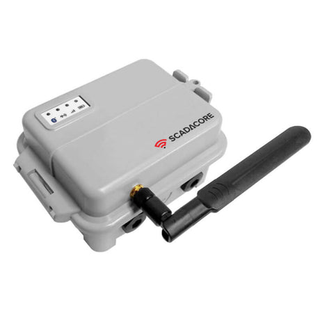 The RKI Instruments' SCADACore device, marketed under the name RKI Telemetry Hardware with Modbus Output 85-VCM, features a prominent gray body with a text logo, accompanied by an attached black antenna and a small indicator panel on top. This sturdy unit is ideal for industrial applications and remote monitoring.