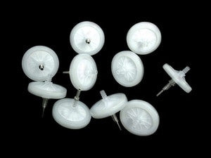 A scattered group of round, white items with transparent tops and metal points, similar to RAE Systems 45 mm External Filters (10/Pack, Product Code 002-3022-010), set against a black background.