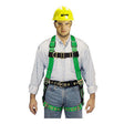 A person wearing a yellow hard hat, safety glasses, and a green Miller DuraFlex Full Body Harness P950-58/UGN by Miller Fall Protection over a light blue shirt and black pants.