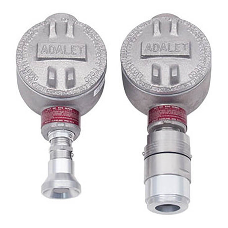 The RKI Direct Connect Gas Sensor LEL, H2 Specific features two industrial metal enclosures prominently branded with "RKI Instruments" on top. These enclosures have cylindrical bases and connectors for securely attaching equipment. Their explosion-proof design ensures safety when used in environments containing toxic gases. Additionally, they exhibit a rugged, metallic finish.