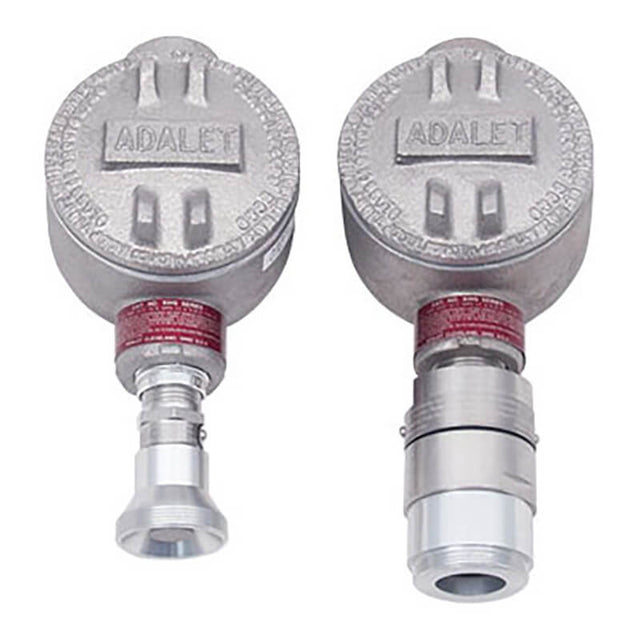 The RKI Direct Connect Gas Sensor LEL, H2 Specific features two industrial metal enclosures prominently branded with "RKI Instruments" on top. These enclosures have cylindrical bases and connectors for securely attaching equipment. Their explosion-proof design ensures safety when used in environments containing toxic gases. Additionally, they exhibit a rugged, metallic finish.